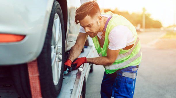 Roadside technician checking a car wheel